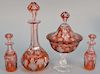 Ten piece lot of cranberry cut to clear three decanters, three covered compotes, and four pieces from castor set. ht. 4 in. to 12 1/...
