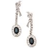 A sapphire and diamond palladium silver pair of earrings.