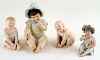 FOUR CONTINENTAL PORCELAIN PIANO BABY FIGURES