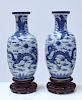 Pair Chinese 19th C. blue and white vases on carved rosewood stands