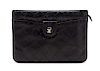 * A Chanel Black Quilted Leather Clutch, 10 x 7 1/2 x 1 1/2 inches.