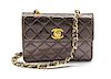 * A Chanel Bronze Quilted Leather Mini Flap Bag, 5 1/2 x 4 x 1 1/2 inches.