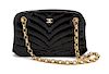 * A Chanel Black Chevron Quilted Patent Leather Bag, 8 x 4 1/2 x 2 inches.