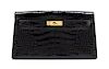 * An Hermes Black Shiny Alligator Kelly Clutch Bag, 11 x 6 x 1 1/2 inches.