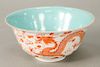 Dragon bowl, China, 20th century, decorated with orange, five-clawed dragon on a white body of incised clouds/waves, the sides risin...