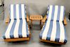 Three piece lot to include pair of Giati Palazzio teak chaise lounge chair with cushions having Sunbrella upholstery and a side tabl...