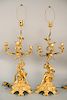Pair of figural gilt bronze candelabras, each having scrolling foliate four arms figural partially clad male on one and female on th...
