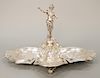 Continental silver epergne with central figure of a woman with four lobbed sides, two with flowers, with touch mark.  ht. 13 1/2 in., wd. 22 in., <...