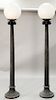 Pair of cast iron outdoor lamps on fluted shaft on round base topped with plastic globes.  ht. 98 in.  Provenance: Property from...