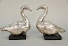 Pair of silver ducks with red glass eyes mounted on wood stands (weighted).  ht. 12 in., lg. 12 in.  Provenance: Property from a...