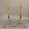 Pair of Chippendale brass andirons, each with top finial over etched urn on turned shafts on etched square bases, set on cabriole le...