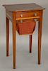 Federal mahogany sewing stand with shaped top over drawer over bag drawer on square tapered legs, circa 1800.  ht. 29 1/2 in., top...