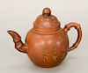 Brown pottery (Yixing) teapot, China, of bulbous shape with bamboo-form handle and spout, incised decoration of calligraphy and bamb...