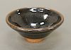 Oil spot stoneware (Jian Yao) tea bowl, China, the dark brown clay body covered overall with an iridescent droplet pattern atop an u...
