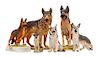 * A Group of Six Porcelain and Ceramic German Shepherds Width of widest 9 1/2 inches.