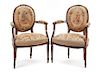 A Pair of Louis XV Style Walnut Fauteuils Height 35 inches.
