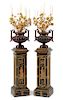 A Pair of French Enameled Cast Iron and Gilt Bronze Candelabra with Associated Painted Pedestals Height overall 69 inches.