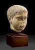 A Roman Marble Head of a Youth Height 8 inches.