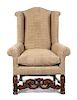 A Jacobean Style Oak Wingback Armchair Height 47 inches.