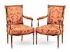 A Pair of Louis XVI Style Walnut Fauteuils Height 38 inches.