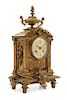 * A French Neoclassical Brass Mantel Clock Height 14 3/4 x width 8 1/4 x depth 4 1/2 inches.