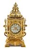 * A Continental Neoclassical Style Brass Mantel Clock Height 18 x width 8 1/2 x depth 6 inches.