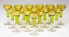 Set of sixteen clear and emerald glass champagnes