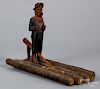 Carved and painted figure of a man on a raft