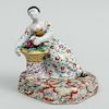 Dutch Polychrome Delft Figure of a Seated Woman with Basket of Grapes