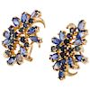 A tanzanite and sapphire 14K yellow gold pair of earrings.