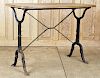 A BLACK PAINTED CAST IRON BISTRO TABLE WOOD TOP