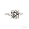 Platinum and Diamond Solitaire, prong-set with a round brilliant-cut diamond weighing 3.17 cts., flanked by tapered baguettes, size 4 3