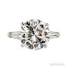 Platinum and Diamond Solitaire, prong-set with a round brilliant-cut diamond weighing 5.81 cts., flanked by tapered baguettes, size 5 3