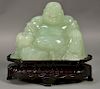 Large carved jade or jadeite figure of a seated buddha. figure: ht. 7 1/4in., lg. 10 1/2in., wd. 11 1/2 in.