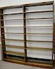Oak bookcases, double (ht. 82 1/2 in., wd. 74 in.) and single (ht. 82 1/2 in., wd. 37 1/2 in.) with recessed panel sides and adjusta...