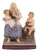 A RUSSIAN PORCELAIN FIGURE OF A PEASANT WOMAN WITH TWO CHILDREN, GARDNER PORCELAIN FACTORY, MOSCOW, LATE 19TH CENTURY
