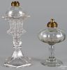 Two colorless glass whale oil lamps, 19th c., 11'' h. and 7 3/4'' h.