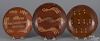 Three Pennsylvania slip decorated redware plates, 19th c., 8'' dia., 8 3/4'' dia., and 9 1/4'' dia.