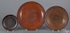 Three Pennsylvania redware plates/shallow bowls, 6 3/4'' dia., 10'' dia., and 12'' dia.