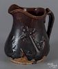 Rockingham glaze pitcher, late 19th c., with relief anchor decoration, 8'' h.