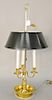 French brass bouillotte table lamp with adjustable tole shade. ht. 29 in. Provenance: An Estate from Farmington, Connecticut