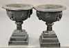 Victorian iron urns with face (one small chip in base of urn, one in need of repair). ht. 24 in., dia. 30 in. Provenance: From the E...