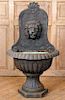 A CAST IRON WALL FOUNTAIN WITH LION MASK
