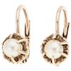 A cultured pearl 12K yellow gold pair of earrings.