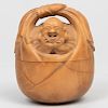 Japanese Carved Boxwood Inro in the Form of an Immortal in a Basket