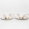 Pair of Egyptian Silver-Mounted Porcelain Teacups and Saucers