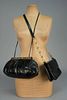 TWO JUDITH LEIBER BLACK REPTILE BAGS with CABOCHONS.