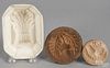 Two carved butter prints, 19th c., with acorn decoration, together with a porcelain sheaf of wheat