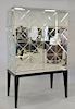 Mirrored two door cabinet on stand, opening to shelved interior. ht. 72 in, wd. 44 1/2 in.