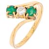A diamond and emerald 18K yellow gold ring.
